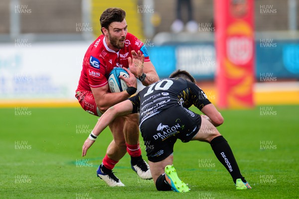 230422 - Dragons v Scarlets - United Rugby Championship - Johnny Williams of Scarlets  is tackled by Sam Davies of Dragons