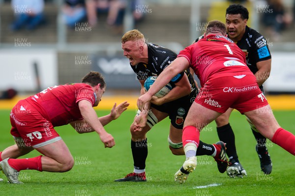 230422 - Dragons v Scarlets - United Rugby Championship - Ben Fry of Dragons is tackled by Ryan Elias of Scarlets 