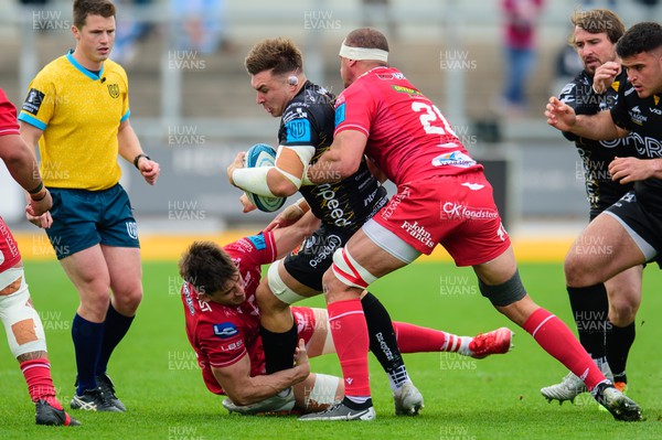 230422 - Dragons v Scarlets - United Rugby Championship - Taine Basham of Dragons is tackled by Aaron Shingler of Scarlets 