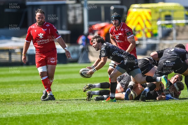 250421 Dragons v Scarlets, Guinness PRO14 Rainbow Cup - Rhodri Williams of Dragons passes the ball out 