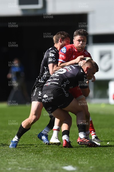 250421 Dragons v Scarlets, Guinness PRO14 Rainbow Cup - Steff Evans of Scarlets is tackled by Dan Babos of Dragons