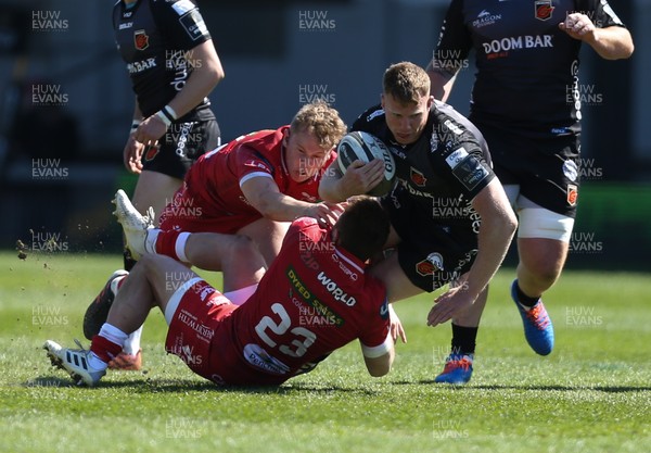250421 Dragons v Scarlets, Guinness PRO14 Rainbow Cup - Jack Dixon of Dragons is tackled by Steff Hughes of Scarlets