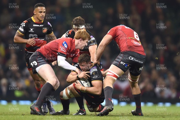 280418 - Dragons v Scarlets - Guinness PRO14 - Elliot Dee of Dragons is tackled by Rhys Patchell and Tadhg Beirne of Scarlets
