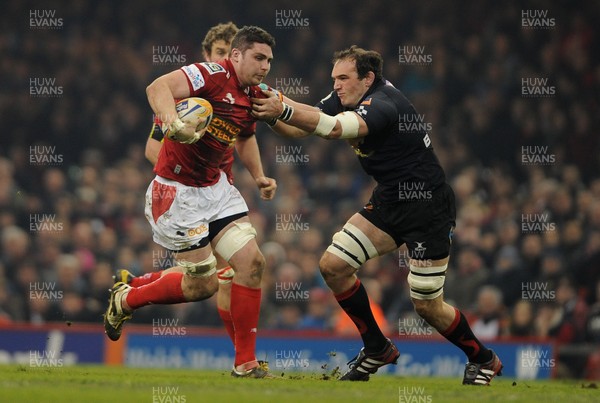 300313 - Newport-Gwent Dragons v Scarlets - RaboDirect PRO12 - Rob McCusker of Scarlets takes on Robert Sidoli of Newport-Gwent Dragons 