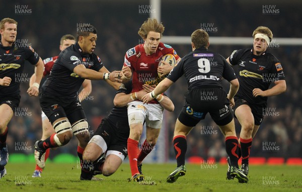 300313 - Newport-Gwent Dragons v Scarlets - RaboDirect PRO12 - Liam Williams of Scarlets is tackled by Patrick Leach of Newport-Gwent Dragons 