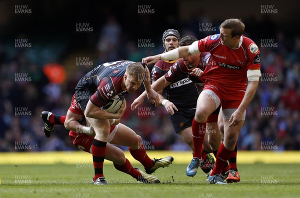 300416 - Newport Gwent Dragons v Scarlets - Judgement Day - Guinness PRO12 - Jack Dixon of Newport Gwent Dragons is tackled by Scott Williams and Hadleigh Parkes of Scarlets