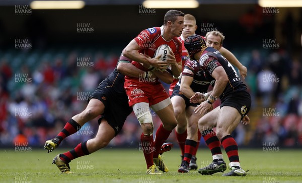 300416 - Newport Gwent Dragons v Scarlets - Judgement Day - Guinness PRO12 - Steven Shingler of Scarlets is tackled by Brok Harris of Newport Gwent Dragons