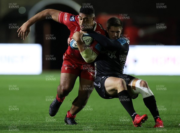 121121 - Dragons A v Scarlets Development - Friendly - Carwyn Tuipulotu of Scarlets is tackled by Tom Griffiths of Dragons