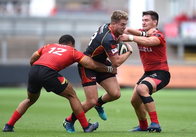 080918 - Dragons v Southern Kings - Guinness PRO14 - Tyler Morgan of Dragons is tackled by Berton Klassen and Michael Willemse of Southern Kings