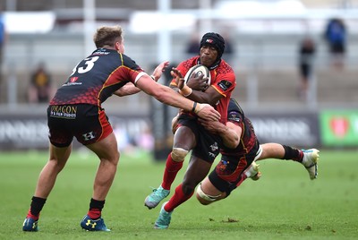 080918 - Dragons v Southern Kings - Guinness PRO14 - Masixole Banda of Southern Kings is tackled by Hallam Amos and Aaron Wainwright of Dragons