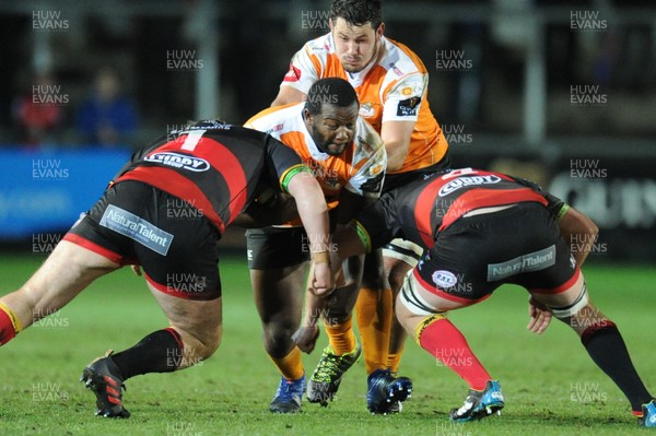 230318 - Dragons v Toyota Cheetahs - Guinness PRO14 - Ox Nche of Toyota Cheetahs is tackled by Sam Hobbs of Dragons and Joe Davies of Dragons
