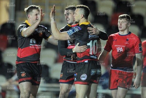 020218 - Dragons v Worcester Warriors - Anglo Welsh Cup -  Dragons Zane Kirchner is congratulated by Jarryd Sage and Jared Rosser after scoring