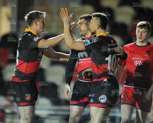 020218 - Dragons v Worcester Warriors - Anglo Welsh Cup -  Dragons Zane Kirchner is congratulated by Jarryd Sage and Jared Rosser after scoring