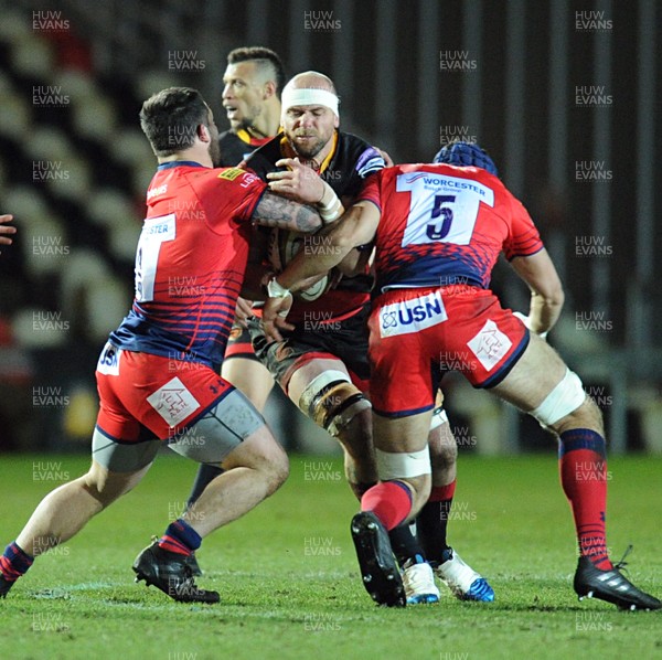 020218 - Dragons v Worcester - Anglo Welsh Cup -  Rynard Landman of the Dragons is tackled by Simon Kerrod and Andrew Kitchener of Worcester
