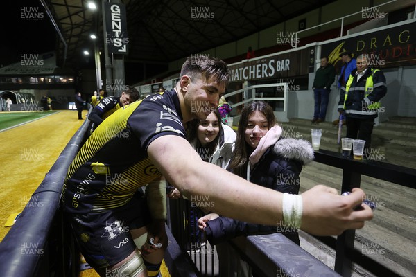 290324 - Dragons v Zebre - United Rugby Championship -  Taine Basham of Dragons with fans at full time