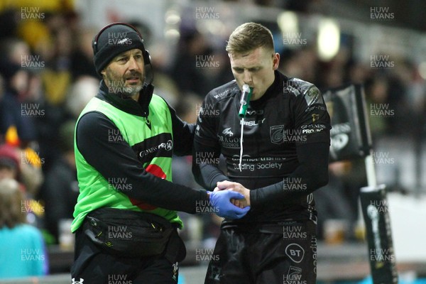 301119 - Dragons v Zebre- Guinness PRO14 -   Dafydd Howells of Dragons is helped from the field by medical staff 