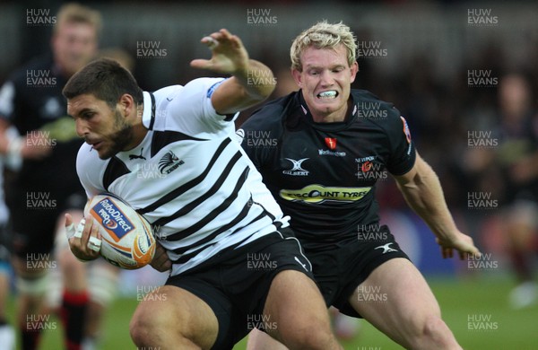 310812 - Newport Gwent Dragons v Zebre, RaboDirect PRO12 -Zebre's Giovanbattista Venditti is tackled by Dragons Patrick Leach   