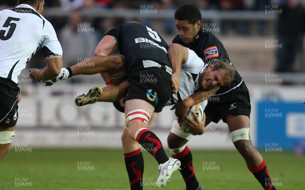 310812 - Newport Gwent Dragons v Zebre, RaboDirect PRO12 -Zebre's Nicola Cattina is held by Dragons Andrew Coombs and Dragons Toby Faletau   