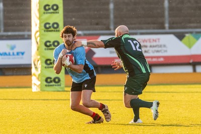 210525 - East District v Mid District - Inter District Cup Final - Troy Theaker of East District is tackled by Shane Lee of Mid District
