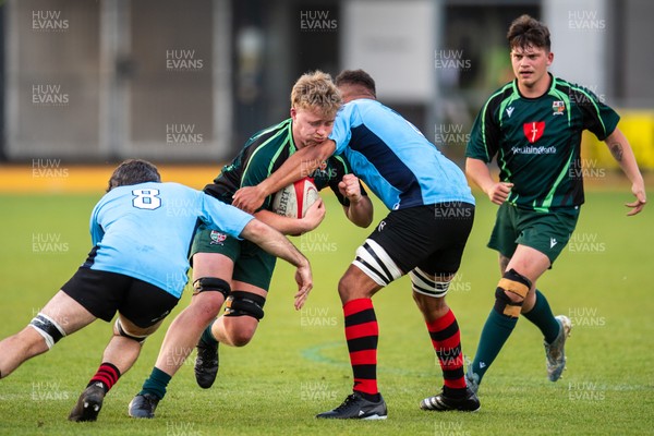 210525 - East District v Mid District - Inter District Cup Final - Issac Pritchard of Mid District is tackled by Rob Jones and Callum Samuel of East District