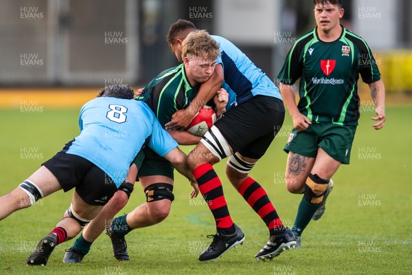 210525 - East District v Mid District - Inter District Cup Final - Issac Pritchard of Mid District is tackled by Rob Jones and Callum Samuel of East District