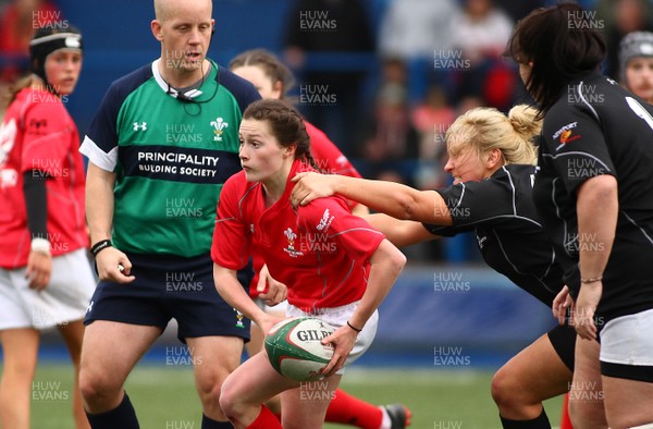 300417 - Under 18s Girls Rugby - East Wales v West Wales - Lucy Packer of West Wales gets the ball away as Molly Philpot of East Wales tackles