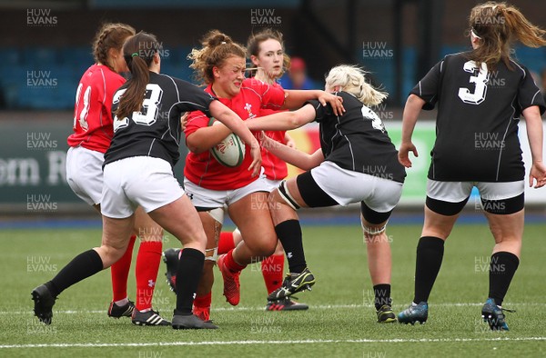 300417 - Under 18s Girls Rugby - East Wales v West Wales - Lleucu George of West Wales is tackled by Ffion Revill(23) and Liliana Podpadec of East Wales