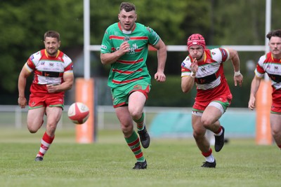 100525 - Ebbw Vale v Llandovery - Super Rygbi Cymru (SRC) Semi Final - Ethan Phillips of Ebbw Vale kicks ahead to score a try under pressure from Harri Doel of Llandovery