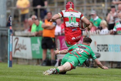 100525 - Ebbw Vale v Llandovery - Super Rygbi Cymru (SRC) Semi Final - Harri Doel of Llandovery vaults over Ewan Bowden of Ebbw Vale