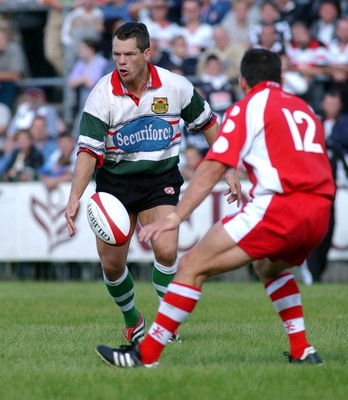 060903 - Ebbw Vale v Pontypridd - Welsh Premiership - Ebbw Vale's Byron Hayward chips past Jason Lewis