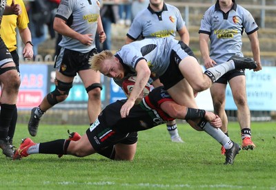 260926 - Ebbw Vale v RGC - Super Rygbi Cymru (SRC) - Louis Williams of RGC is tackled by Liam Lewis of Ebbw Vale