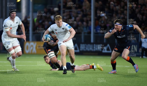 150423 - Edinburgh Rugby v Ospreys - United Rugby Championship - Iestyn Hopkins of Ospreys is tackled by Sam Skinner as Hamish Watson closes in (R)