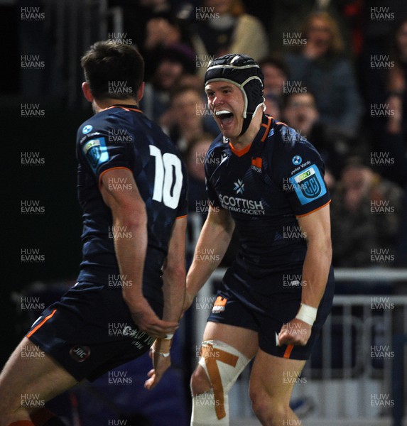150423 - Edinburgh Rugby v Ospreys - United Rugby Championship - Darcy Graham of Edinburgh celebrates with Blair Kinghorn (10) after scoring his second try of the match