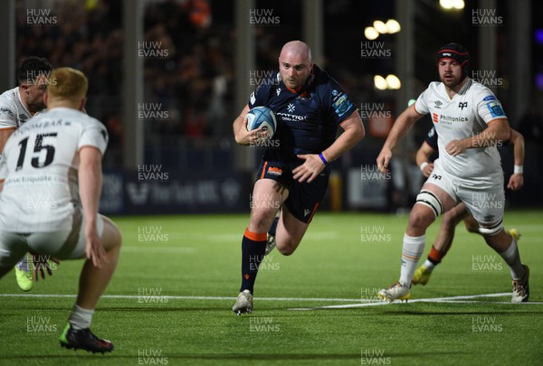 150423 - Edinburgh Rugby v Ospreys - United Rugby Championship - Dave Cherry of Edinburgh thunders towards the Ospreys line as Iestyn Hopkins (15) closes in to tackle