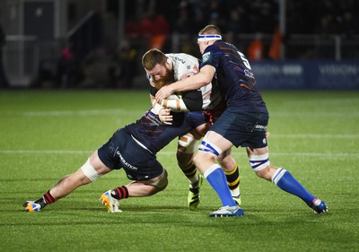 270226 - Edinburgh Rugby v Scarlets - United Rugby Championship - Jake Ball of Scarlets drives through the tackles of Glen Young of Edinburgh (R) and Ben Muncaster of Edinburgh