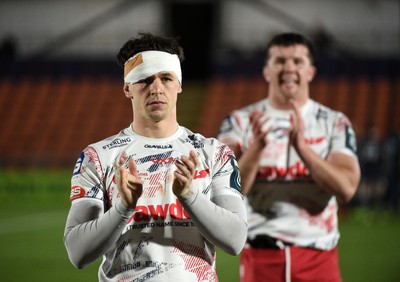270226 - Edinburgh Rugby v Scarlets - United Rugby Championship - Joe Roberts of Scarlets centre (L) leaves the field dejected following a 24-19 defeat