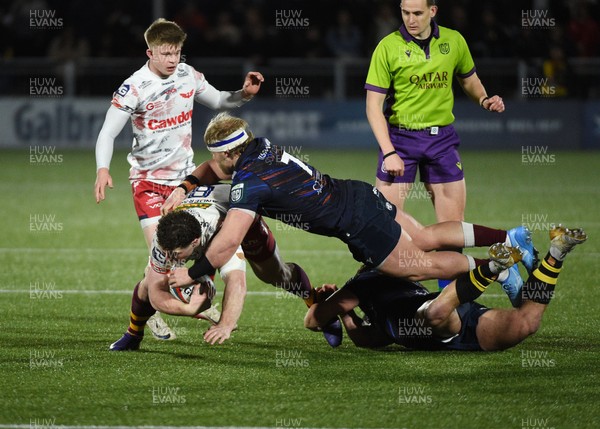 270226 - Edinburgh Rugby v Scarlets - United Rugby Championship - Fletcher Anderson of Scarlets caught by the flying tackle of Dylan Richardson of Edinburgh