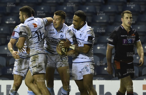 230219 - Edinburgh Rugby v Cardiff Blues - Guinness PRO14 -  Jason Harries of Cardiff celebrates scoring  the winning try with his team mates with a dejected Mark Bennett of Edinburgh