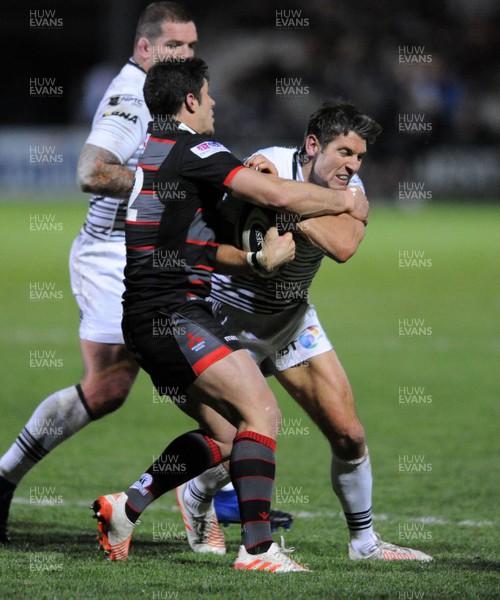 041117 - Edinburgh Rugby v Ospreys - Guinness PRO14 -  James Hook of Ospreys is tackled by opposite number Phil Burleigh