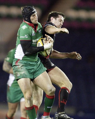 26.03.10 Edinburgh v Scarlets... Edinburgh's John Houston (R) beaten by Scarlets's Andy Fenby (L) 