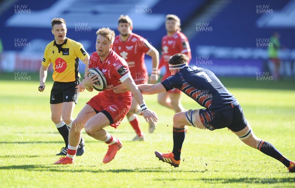 270221 - Edinburgh Rugby v Scarlets - Guinness PRO14 - Tyler Morgan of Scarlets breaks through the tackle of Ally Miller
