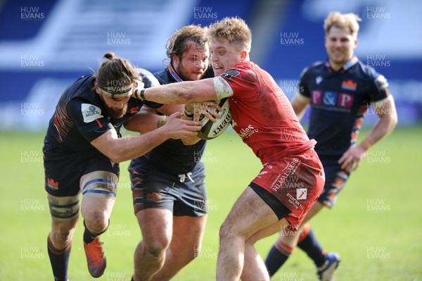 270221 - Edinburgh Rugby v Scarlets - Guinness PRO14 - Tyler Morgan of Scarlets is scragged by Ally Miller and Pierre Schoeman as he gets his collar felt in the tackle