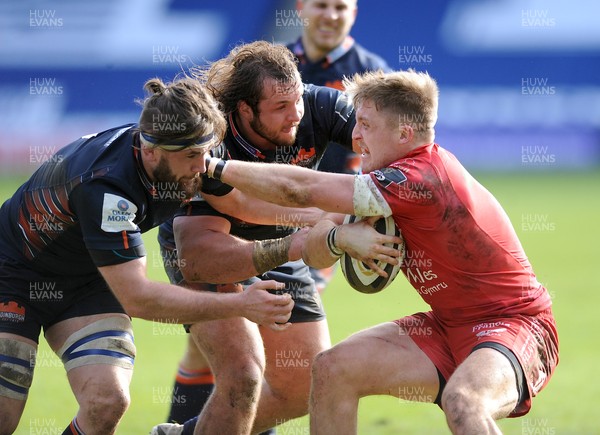 270221 - Edinburgh Rugby v Scarlets - Guinness PRO14 - Tyler Morgan of Scarlets is scragged by Ally Miller and Pierre Schoeman as he gets his collar felt in the tackle