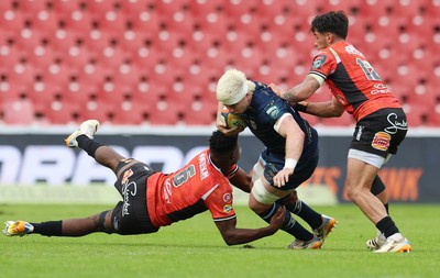 280326 - Fidelity SecureDrive Lions v Dragons RFC, United Rugby Championship - Aaron Wainwright of Dragons RFC takes on Siba Mahashe of Lions and Bronson Mills of Lions