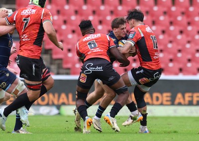 280326 - Fidelity SecureDrive Lions v Dragons RFC, United Rugby Championship - Huw Anderson takes on Siba Mahashe of Lions and Bronson Mills of Lions