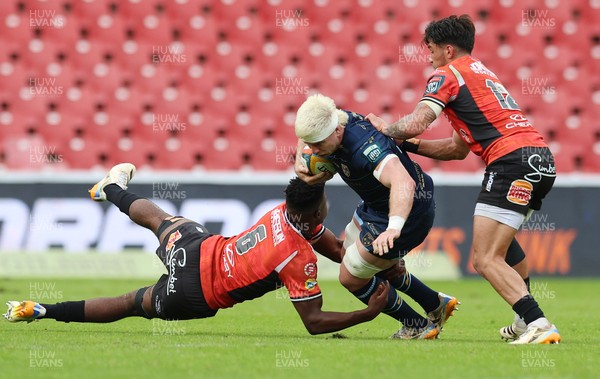 280326 - Fidelity SecureDrive Lions v Dragons RFC, United Rugby Championship - Aaron Wainwright of Dragons RFC takes on Siba Mahashe of Lions and Bronson Mills of Lions