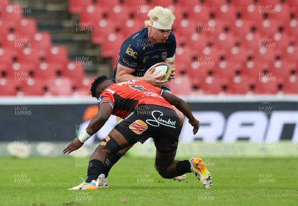 280326 - Fidelity SecureDrive Lions v Dragons RFC, United Rugby Championship - Aaron Wainwright of Dragons RFC takes on Siba Mahashe of Lions