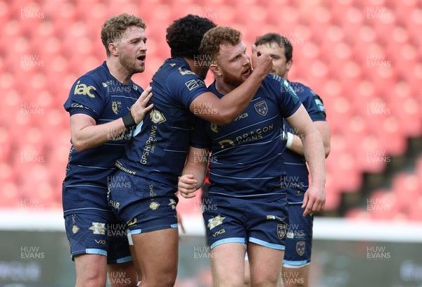 280326 - Fidelity SecureDrive Lions v Dragons RFC, United Rugby Championship - Aneurin Owen of Dragons celebrates with team mates after scoring a try