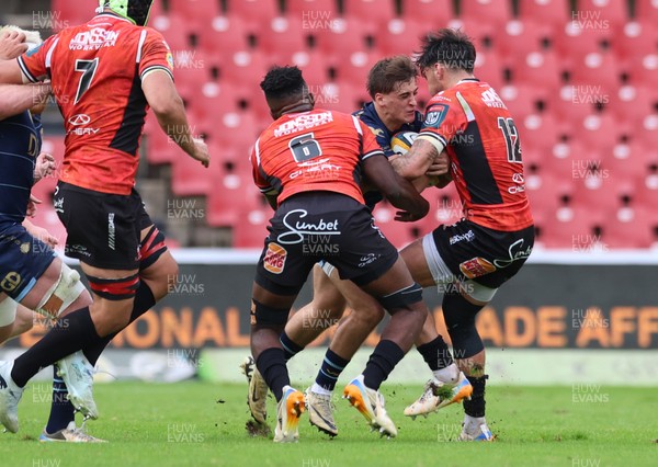 280326 - Fidelity SecureDrive Lions v Dragons RFC, United Rugby Championship - Huw Anderson takes on Siba Mahashe of Lions and Bronson Mills of Lions