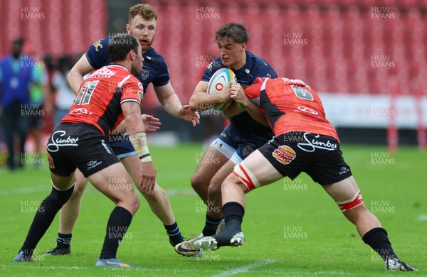 280326 - Fidelity SecureDrive Lions v Dragons RFC, United Rugby Championship - Huw Anderson of Dragons is held by Erich Cronje and Francke Horn of Fidelity SecureDrive Lions